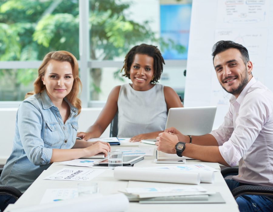 Happy smiling business team at meeting table